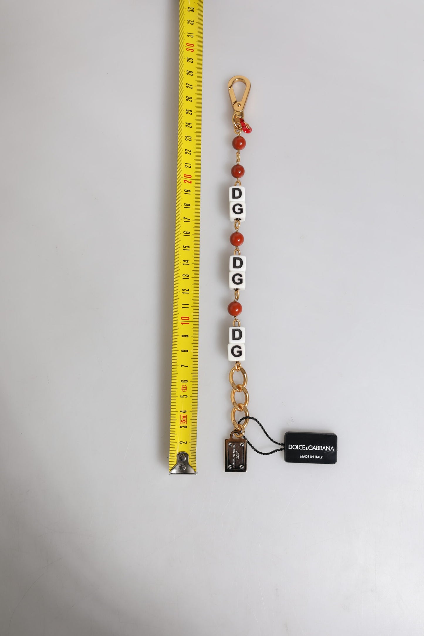 Pulsera Dolce & Gabbana con cadena de latón dorado multicolor y logotipo de DG Dice